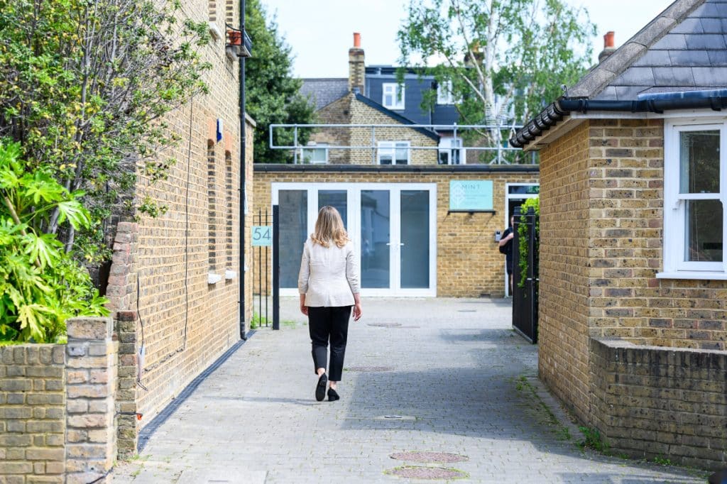 Photo of a woman walking on the path towards Mint Wellbeing