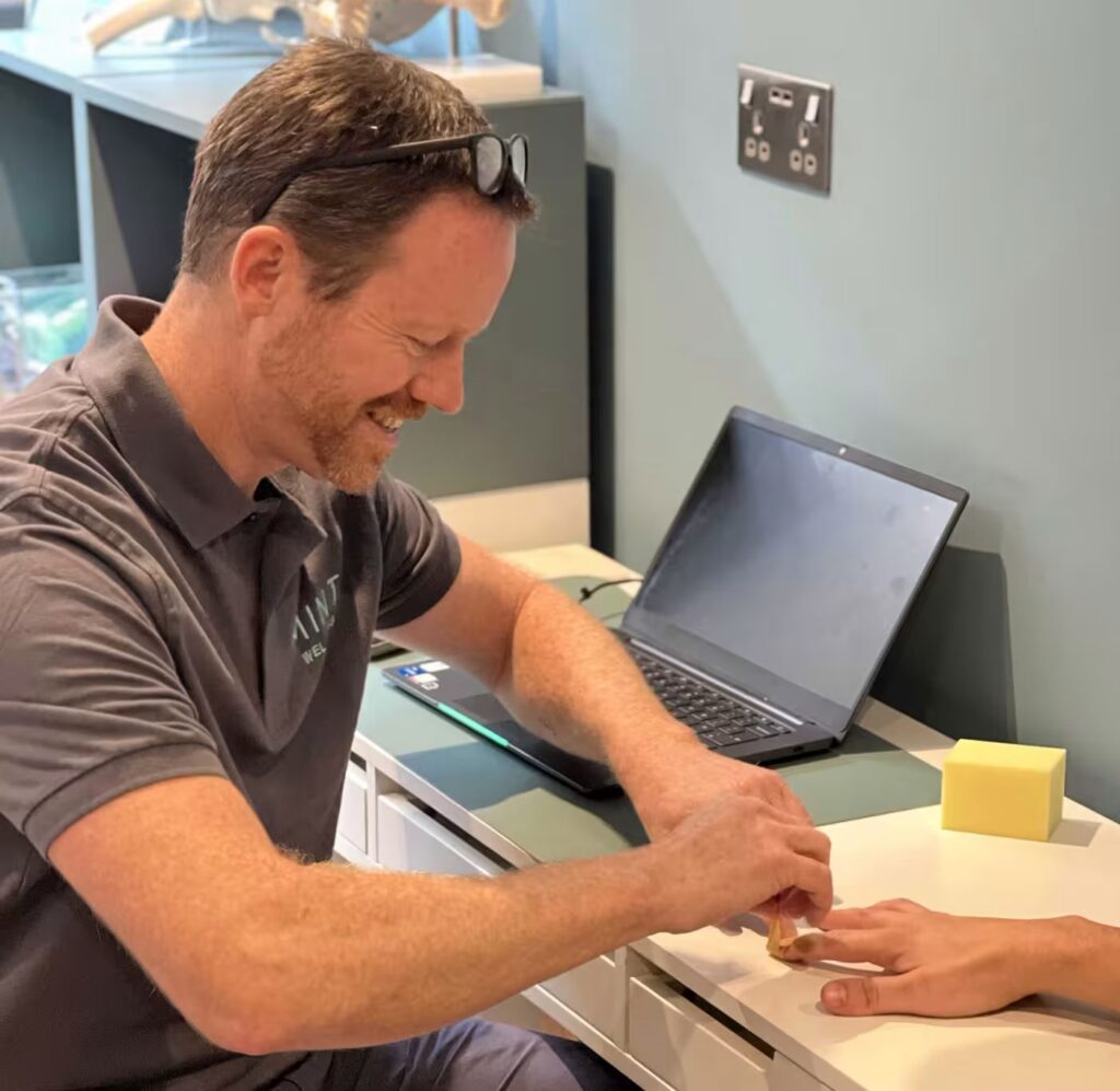 Photo of a hand therapist assessing a patient's hand and wrist in a clinic