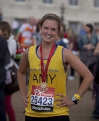 Amy Gasson smiling in her running vest and finisher’s medal after the London Marathon