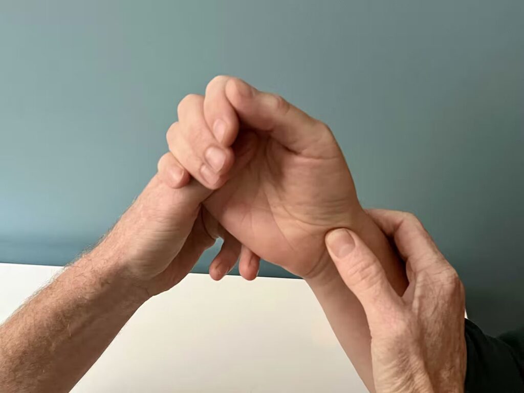 Photo of a hand therapist assessing a patient's hand and wrist